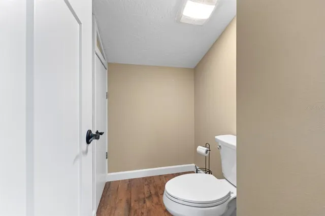a white toilet sitting next to a shower