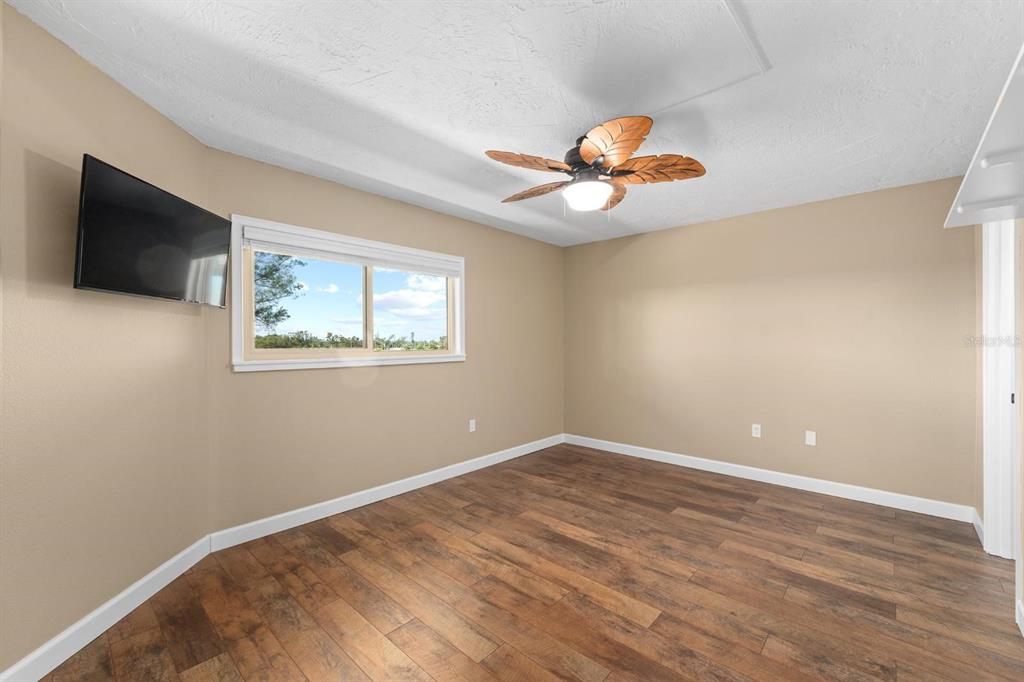 9604 Cortez Road West, Unit 136 Bradenton, FL 34210 - Photo 27 of 39 a view of an empty room with wooden floor and a window