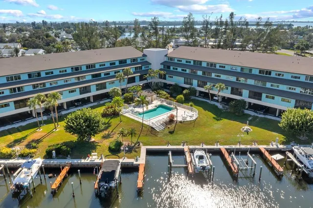 aerial view of a house with a swimming pool and lake view