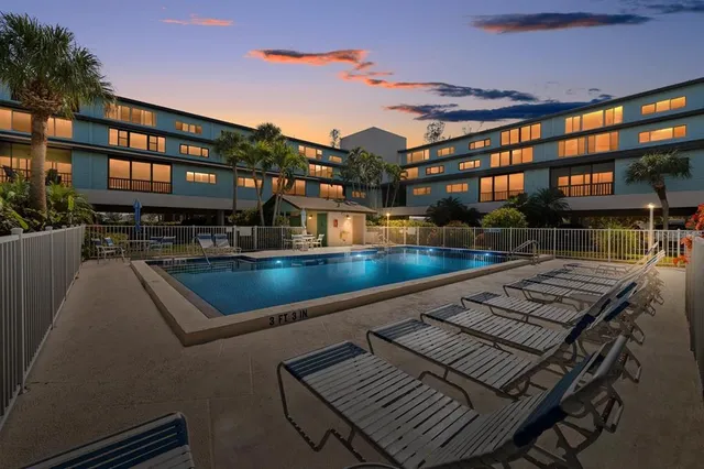 a view of a swimming pool with a lounge chairs