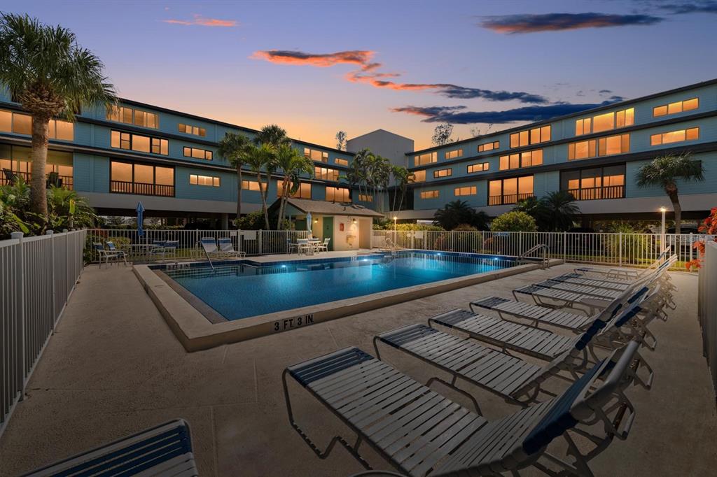 9604 Cortez Road West, Unit 136 Bradenton, FL 34210 - Photo 31 of 39 a view of a swimming pool with a lounge chairs