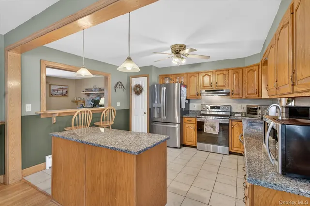 a dining room with furniture and a floor to ceiling window
