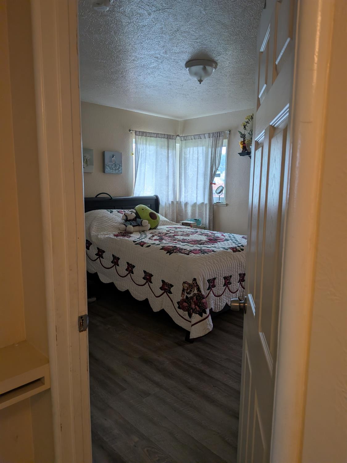 5209 North Angus Street Fresno, CA 93710 - Photo 16 of 33 a bedroom with a bed and wooden floor