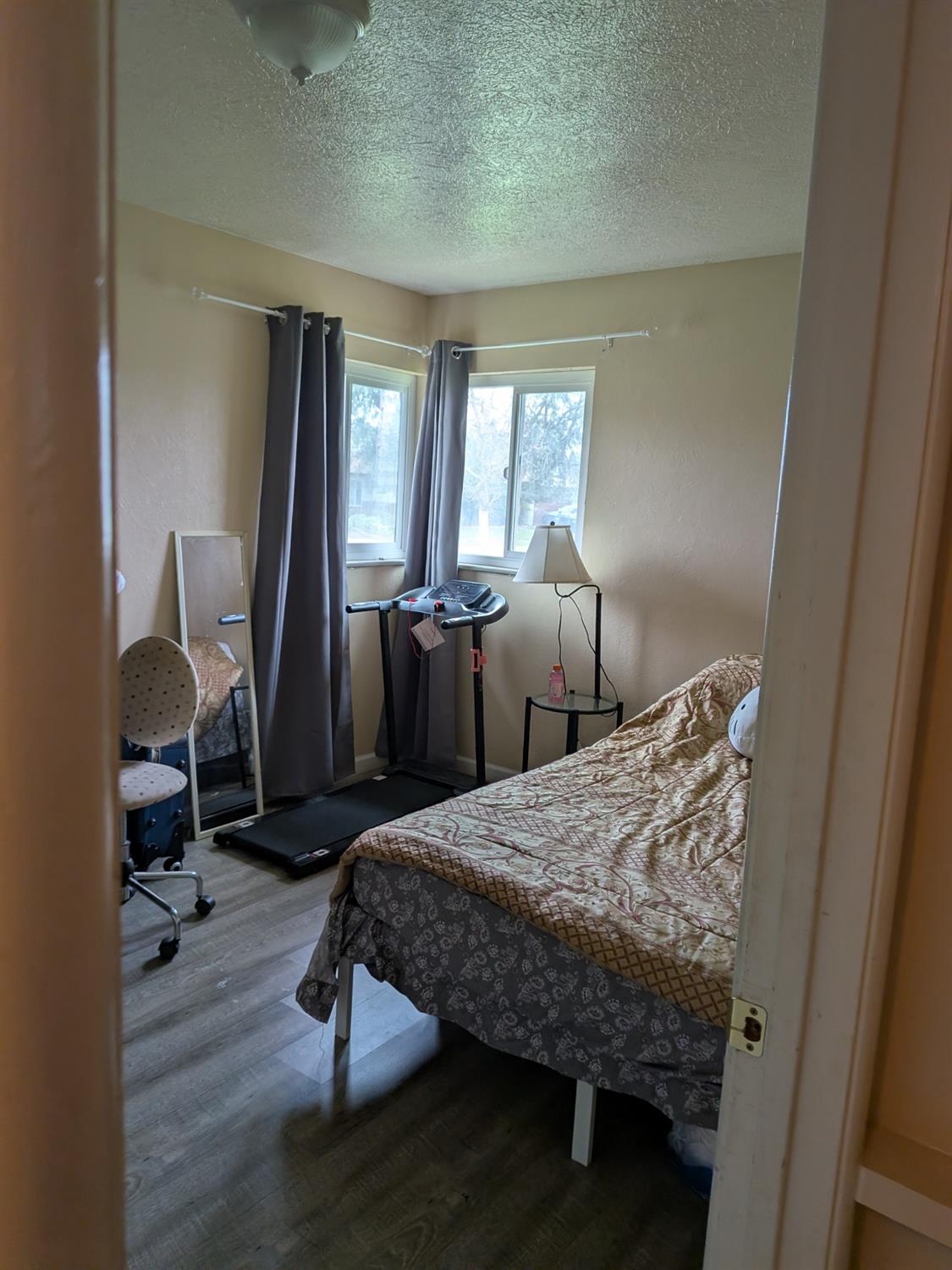 5209 North Angus Street Fresno, CA 93710 - Photo 18 of 33 a bedroom with a bed and wooden floor