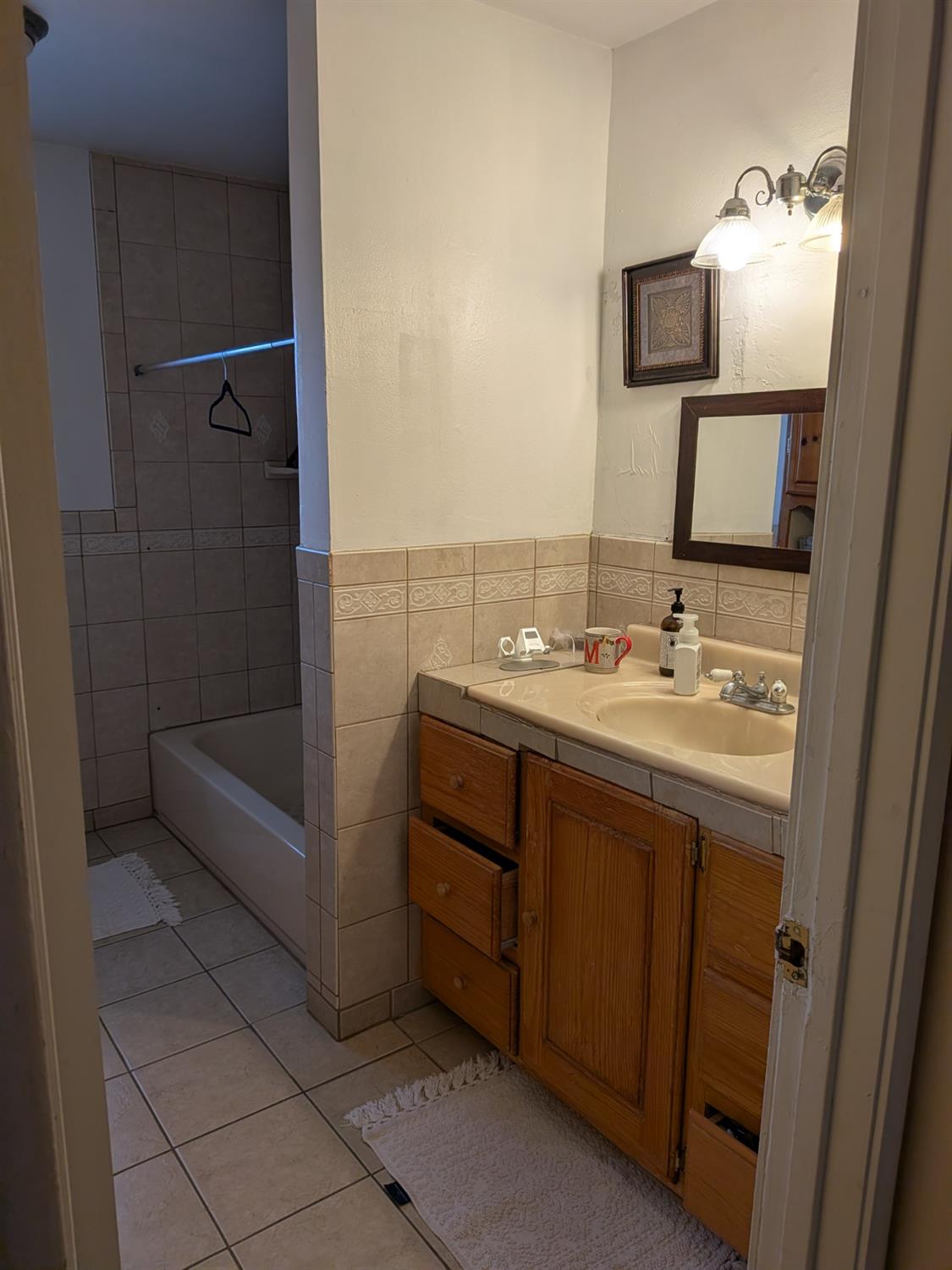 5209 North Angus Street Fresno, CA 93710 - Photo 23 of 33 a bathroom with a sink and a mirror