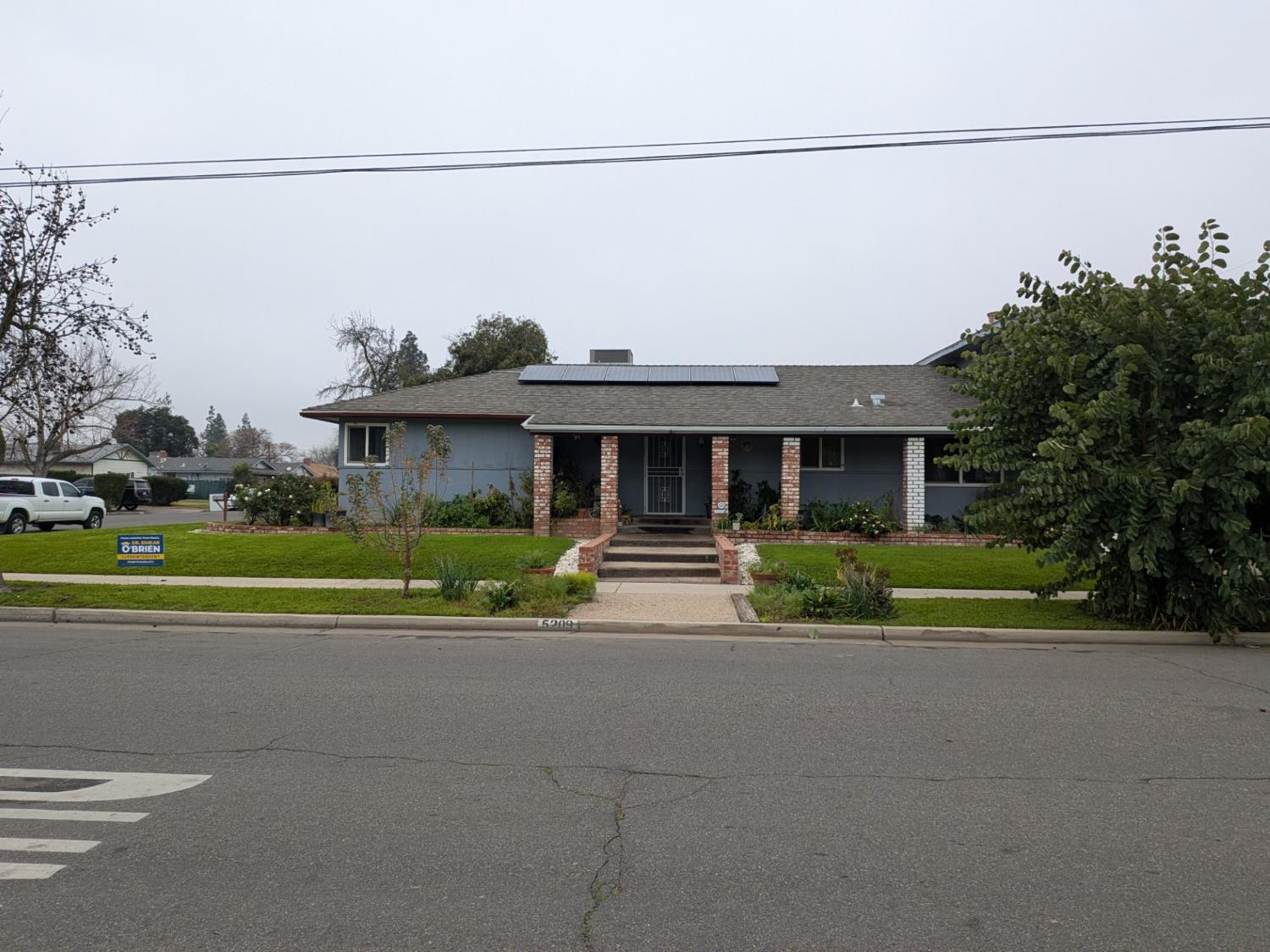 5209 North Angus Street Fresno, CA 93710 - Photo 5 of 33 a front view of a house with a yard and potted plants