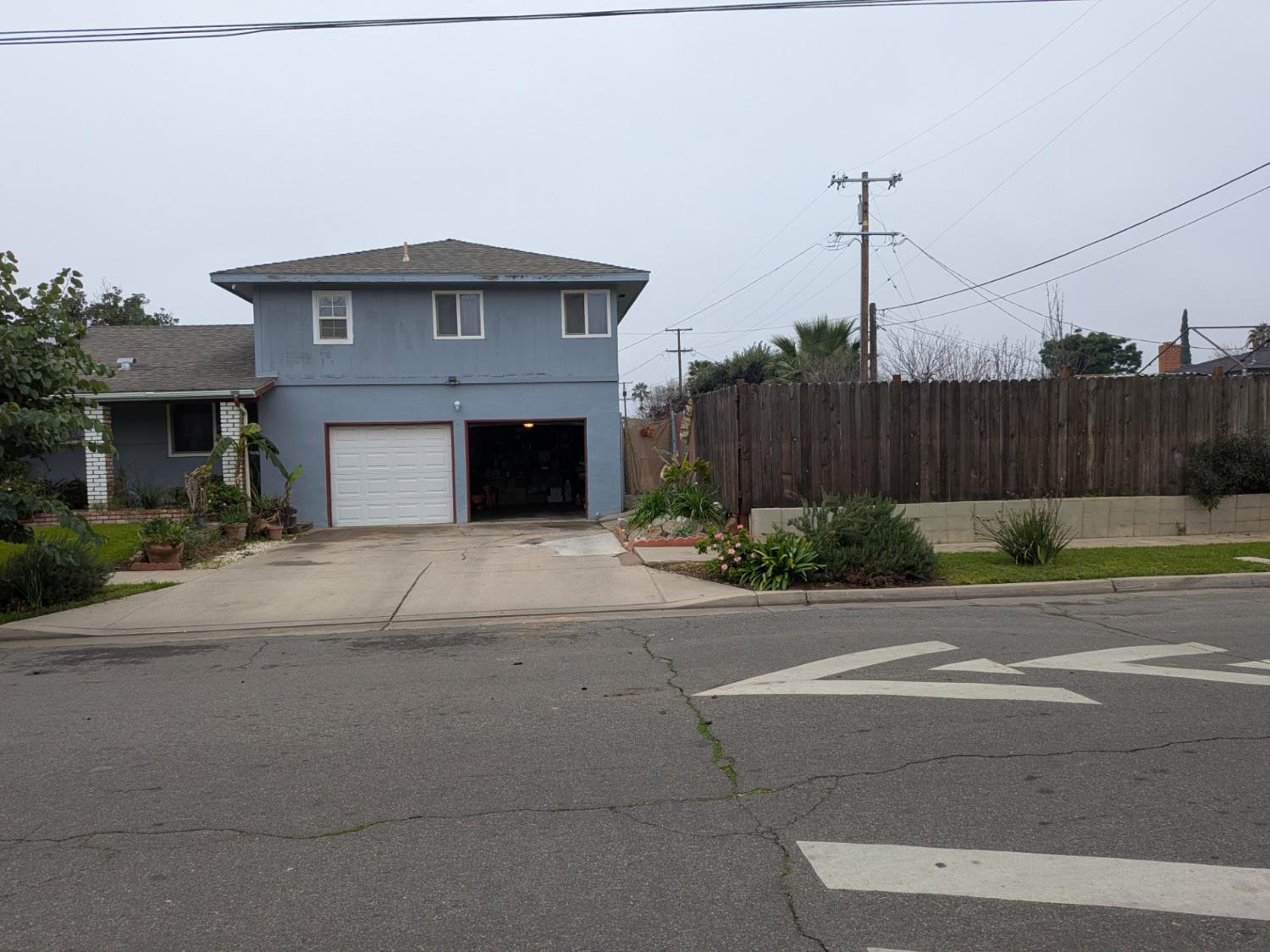 5209 North Angus Street Fresno, CA 93710 - Photo 9 of 33 a front view of a house with a yard and garage