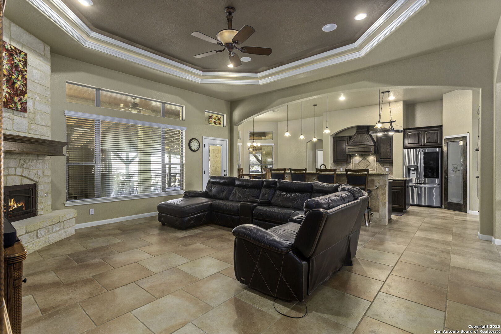 133 Copper Ridge Drive La Vernia, TX 78121 - Photo 11 of 35 a large living room with stainless steel appliances kitchen island granite countertop furniture and a fireplace