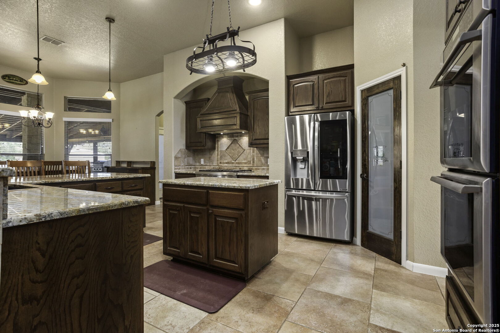 133 Copper Ridge Drive La Vernia, TX 78121 - Photo 16 of 35 a kitchen with stainless steel appliances granite countertop a refrigerator and a stove top oven