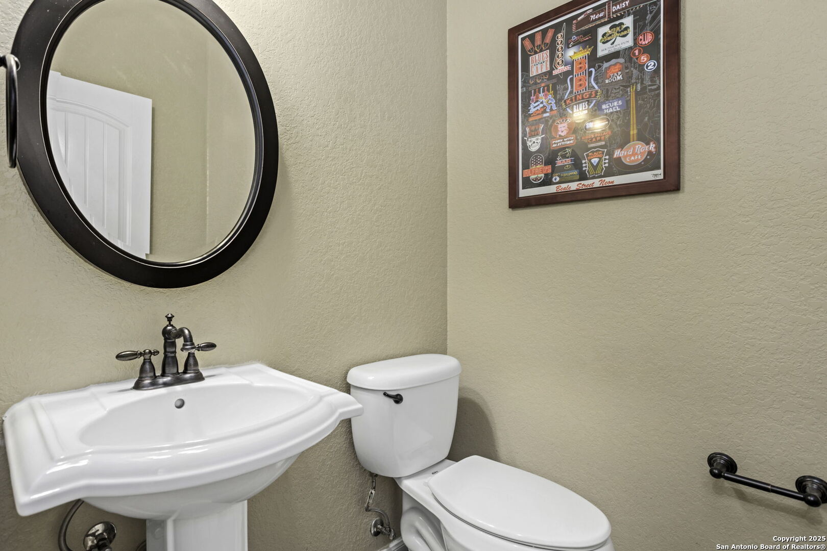 133 Copper Ridge Drive La Vernia, TX 78121 - Photo 25 of 35 a bathroom with a toilet a sink and a mirror