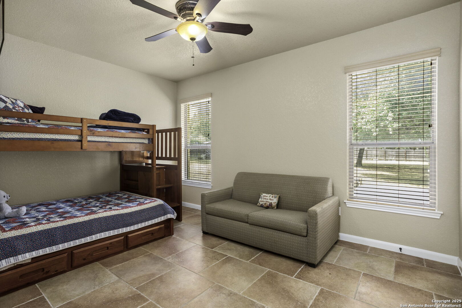 133 Copper Ridge Drive La Vernia, TX 78121 - Photo 28 of 35 a bedroom with a bed and a chandelier