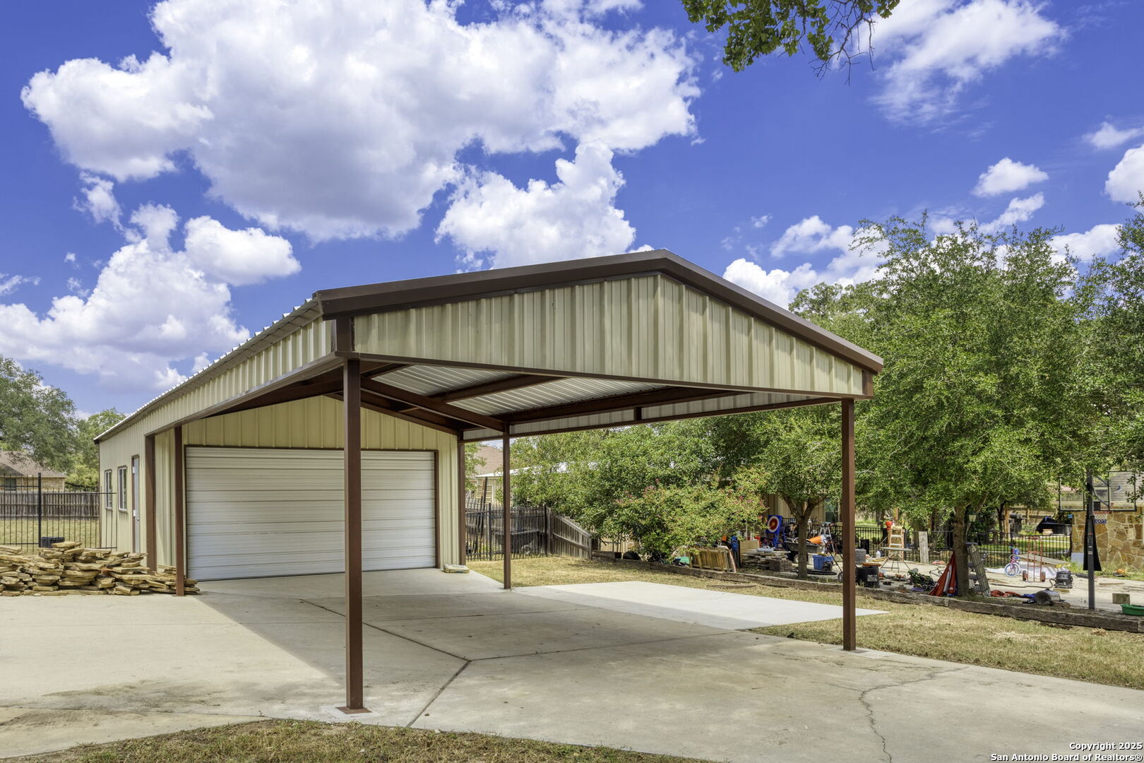 133 Copper Ridge Drive La Vernia, TX 78121 - Photo 3 of 35 a view of a terrace with a table and chairs under an umbrella