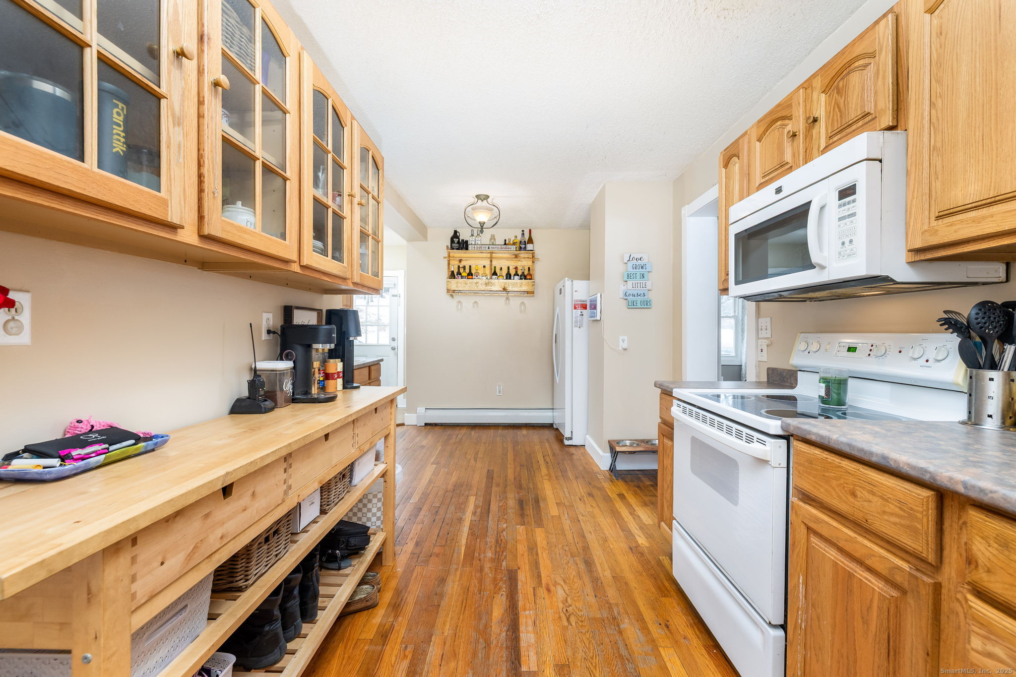 37 Carpenter Road Bolton, CT 06043 - Photo 4 of 17 a kitchen with stainless steel appliances granite countertop a lot of counter space and wooden floors