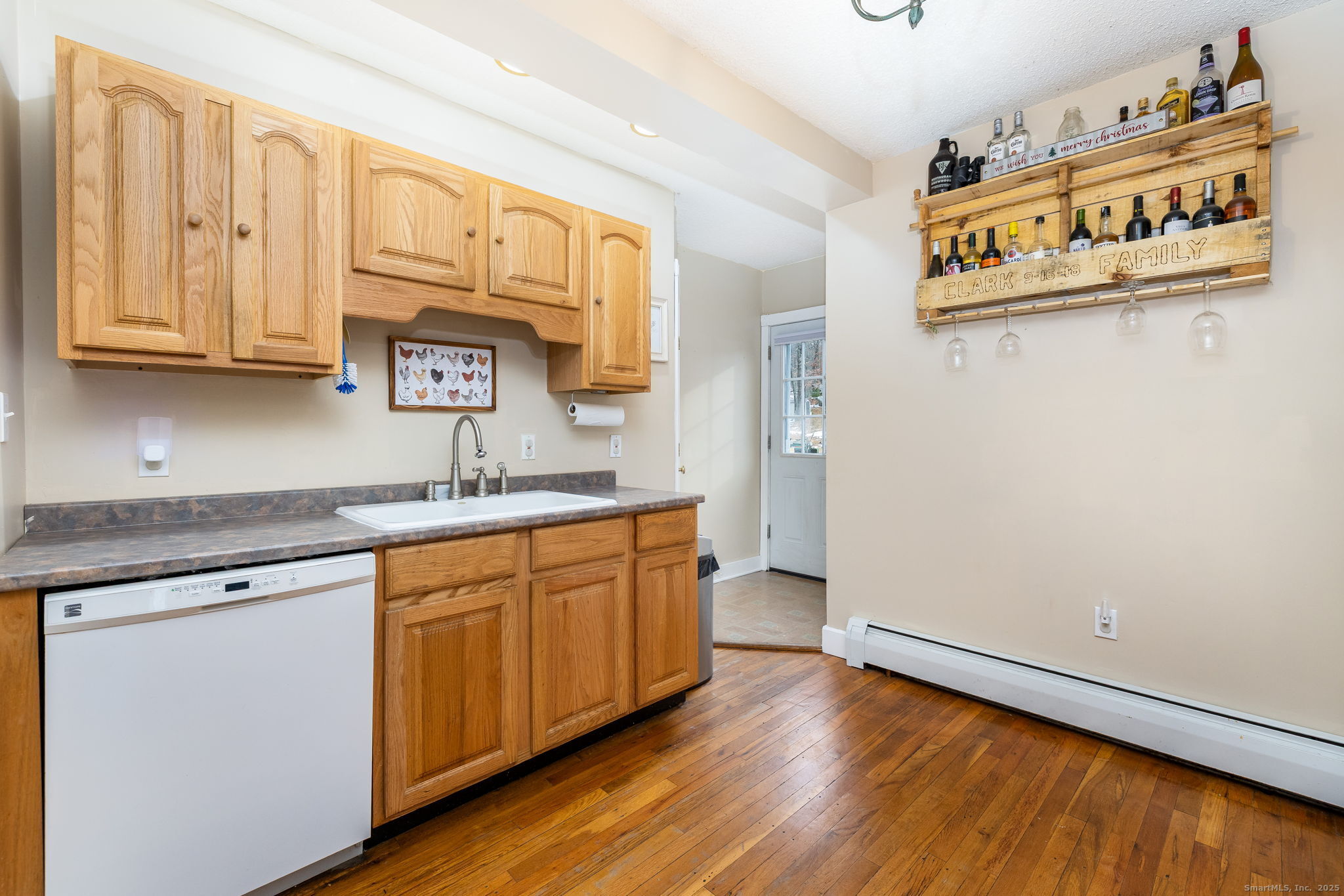 37 Carpenter Road Bolton, CT 06043 - Photo 7 of 17 a kitchen with stainless steel appliances granite countertop a sink and cabinets with wooden floor