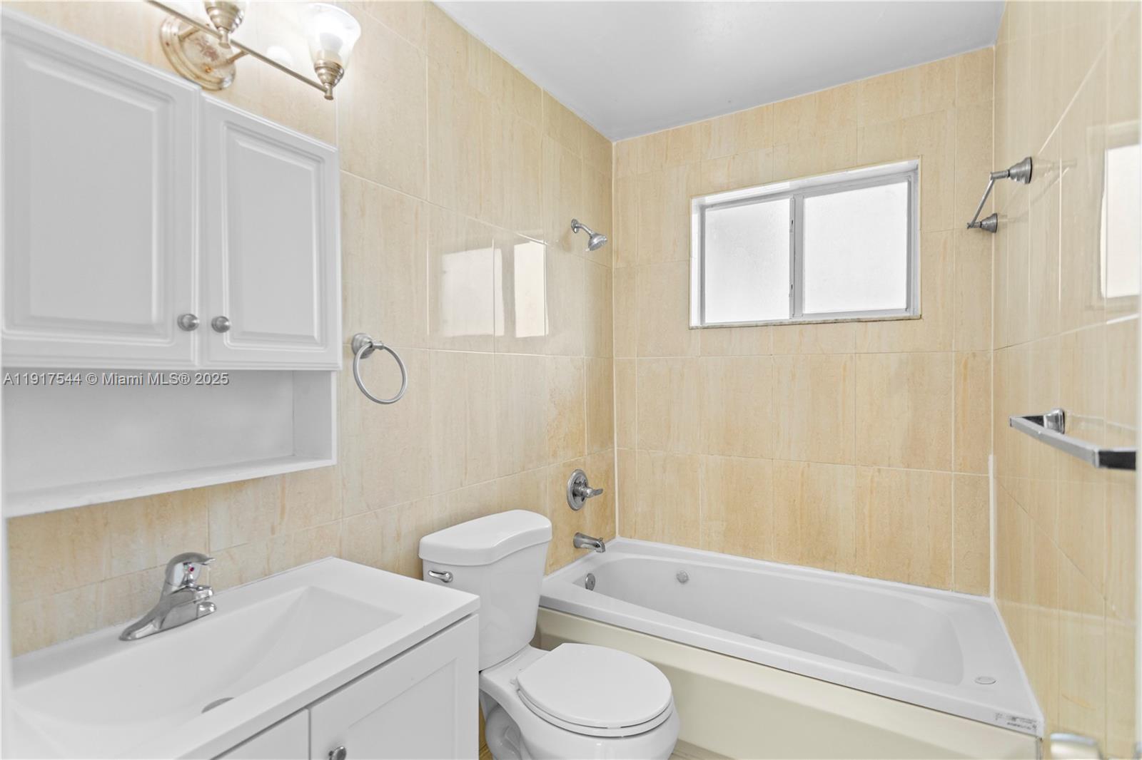 1831 Southwest 97th Terrace Miramar, FL 33025 - Photo 12 of 61 a bathroom with a sink a toilet and bathtub