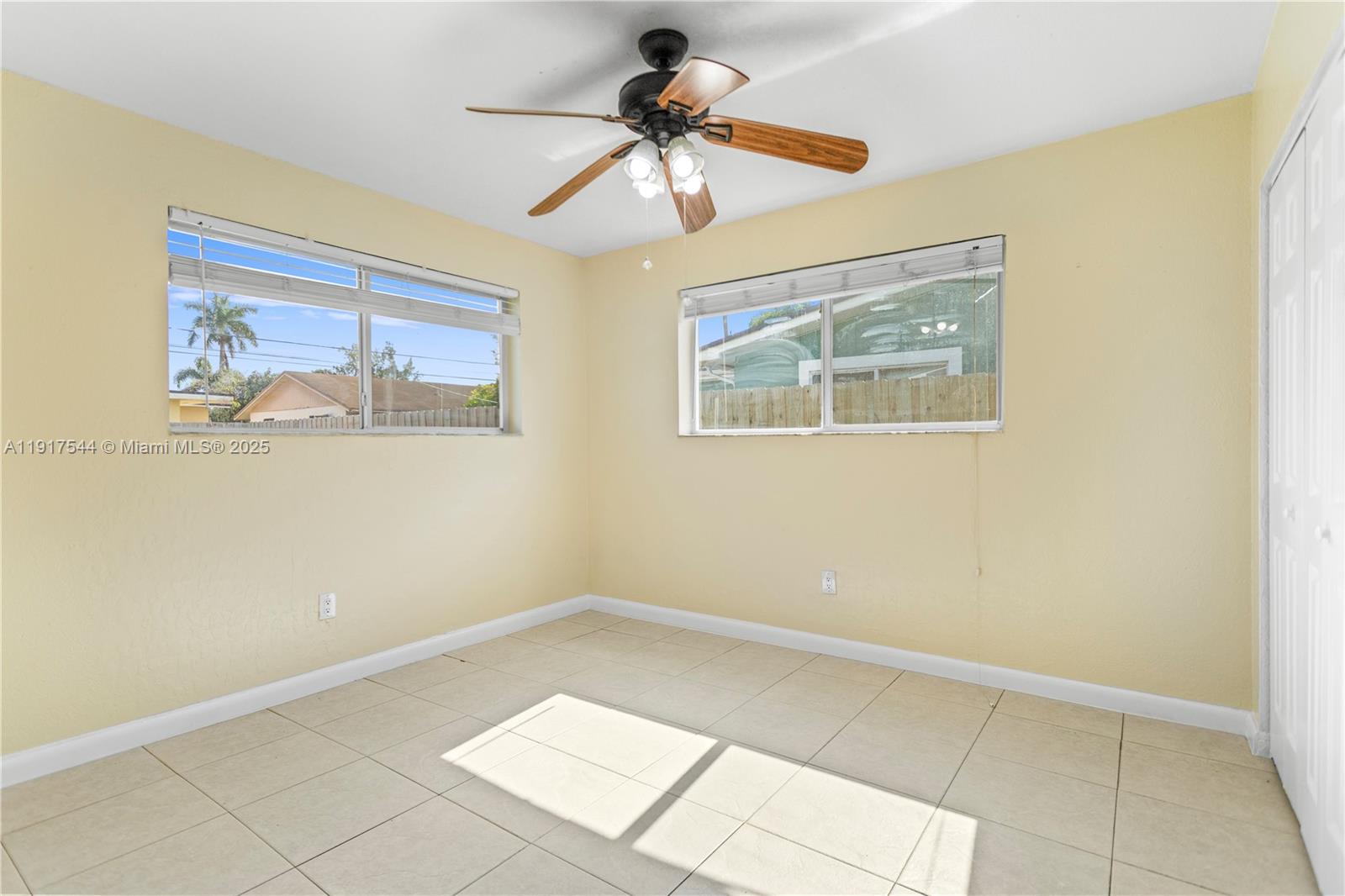 1831 Southwest 97th Terrace Miramar, FL 33025 - Photo 14 of 61 a room with a window and a chandelier fan