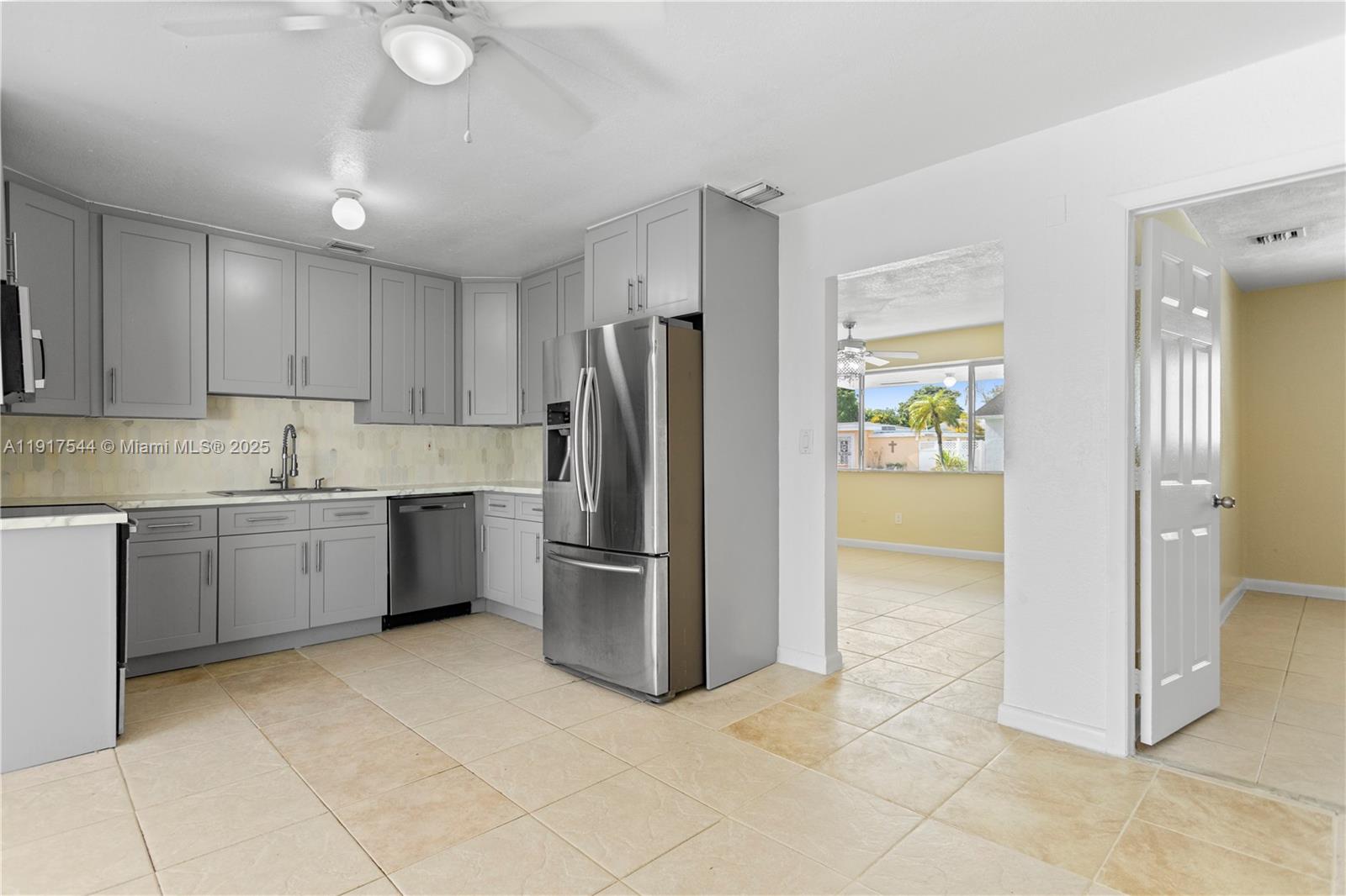 1831 Southwest 97th Terrace Miramar, FL 33025 - Photo 19 of 61 a kitchen with granite countertop a refrigerator and a sink