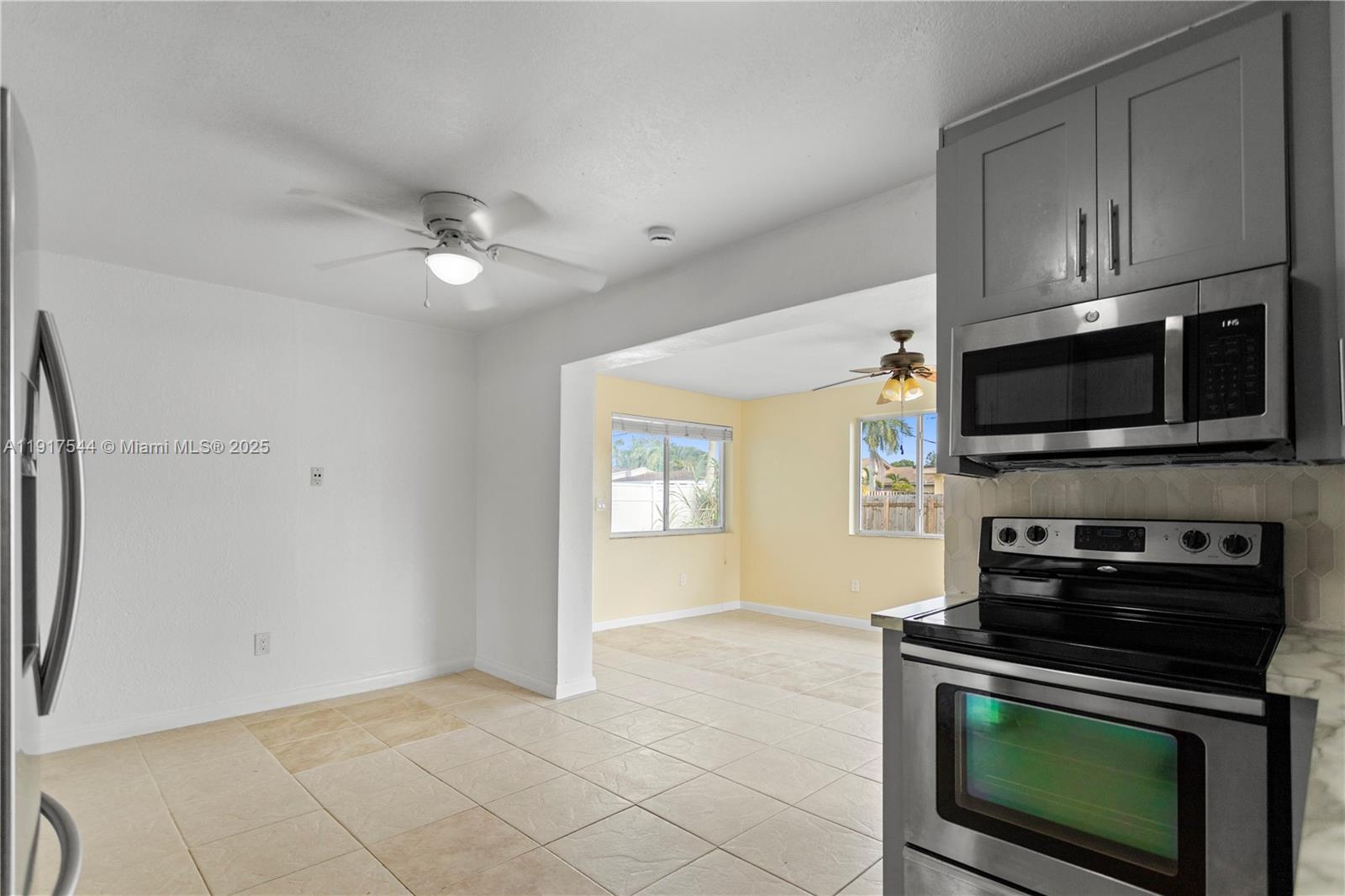 1831 Southwest 97th Terrace Miramar, FL 33025 - Photo 22 of 61 a kitchen with stainless steel appliances a stove a microwave and cabinets