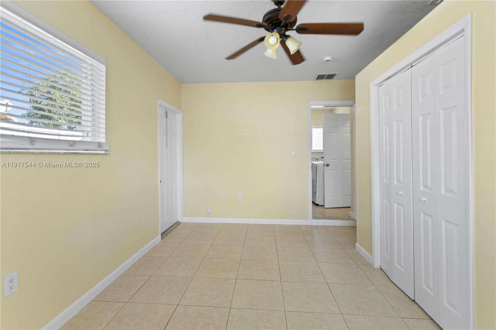 1831 Southwest 97th Terrace Miramar, FL 33025 - Photo 44 of 61 a view of a hallway with a chandelier fan and windows