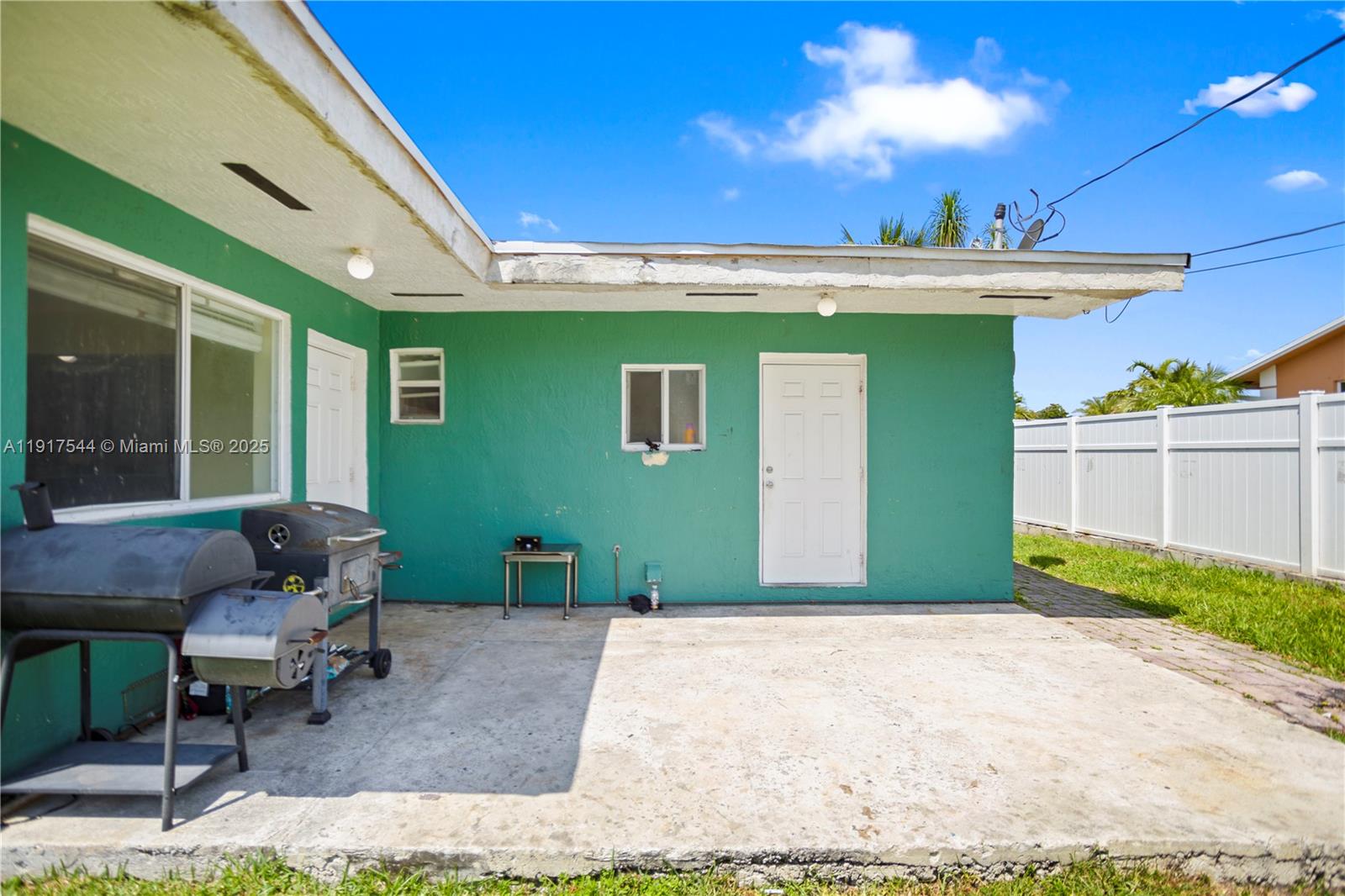 1831 Southwest 97th Terrace Miramar, FL 33025 - Photo 56 of 61 a view of a patio with table and chairs with wooden floor and fence