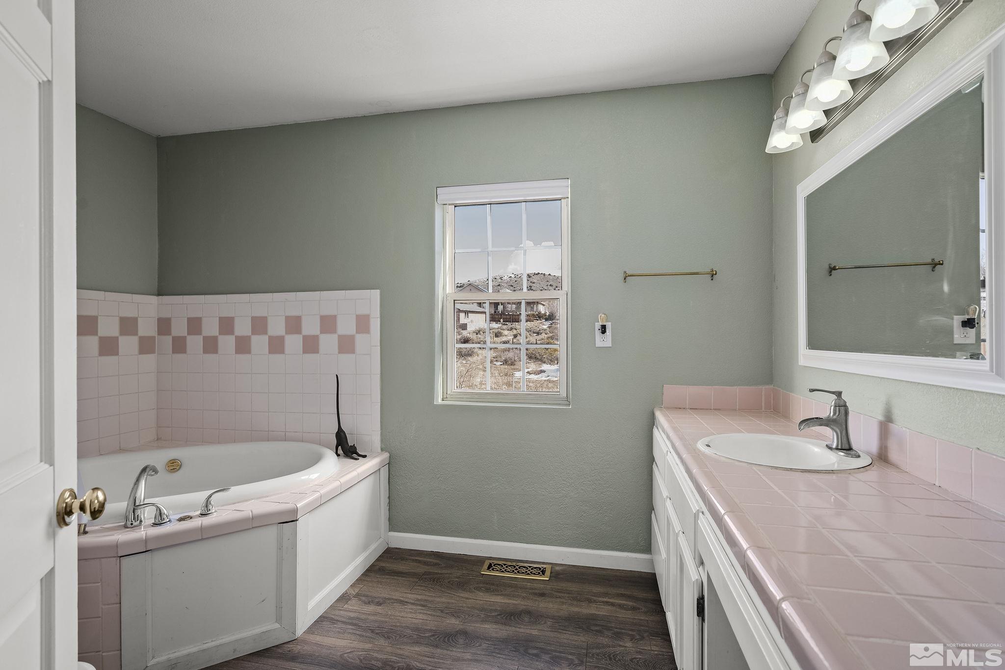 5960 Mallow Road Carson City, NV 89701 - Photo 16 of 34 a bathroom with a tub sink and mirror