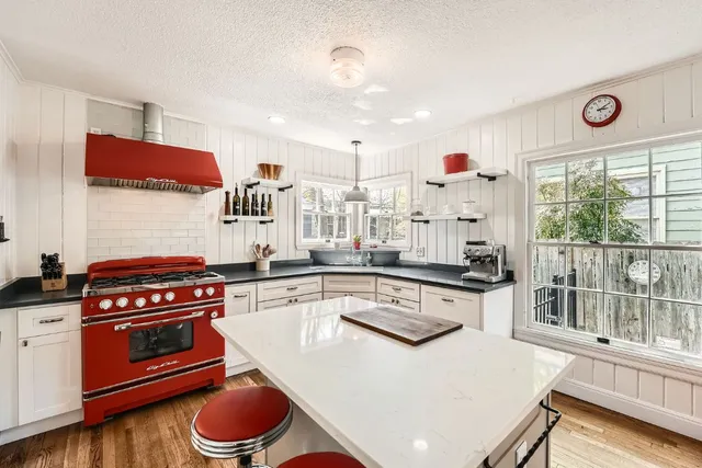 a kitchen with a stove a sink and a refrigerator