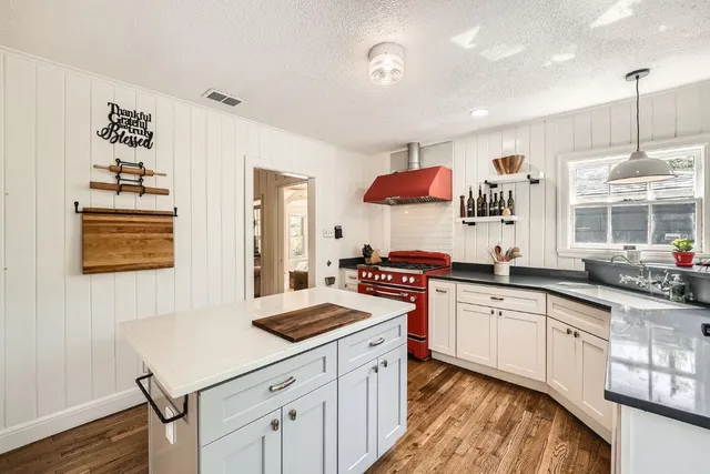 a kitchen with stainless steel appliances a stove a sink dishwasher and a refrigerator