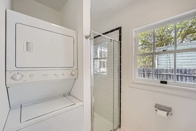 a bathroom with a toilet next to a window