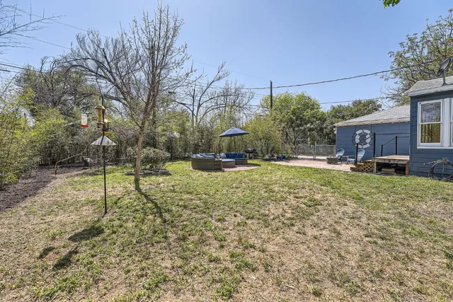 a backyard of a house with table and chairs