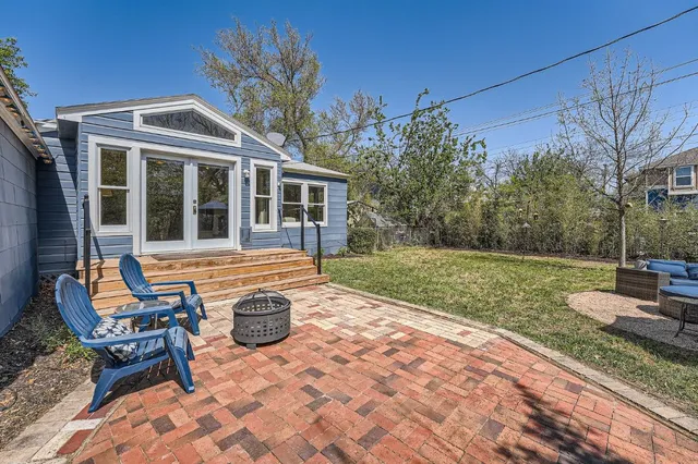 a view of a house with backyard and sitting area