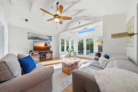 a kitchen with stainless steel appliances granite countertop a sink dishwasher and cabinets with wooden floor