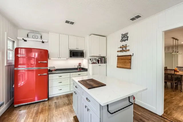 a kitchen with stainless steel appliances a stove refrigerator sink and cabinets