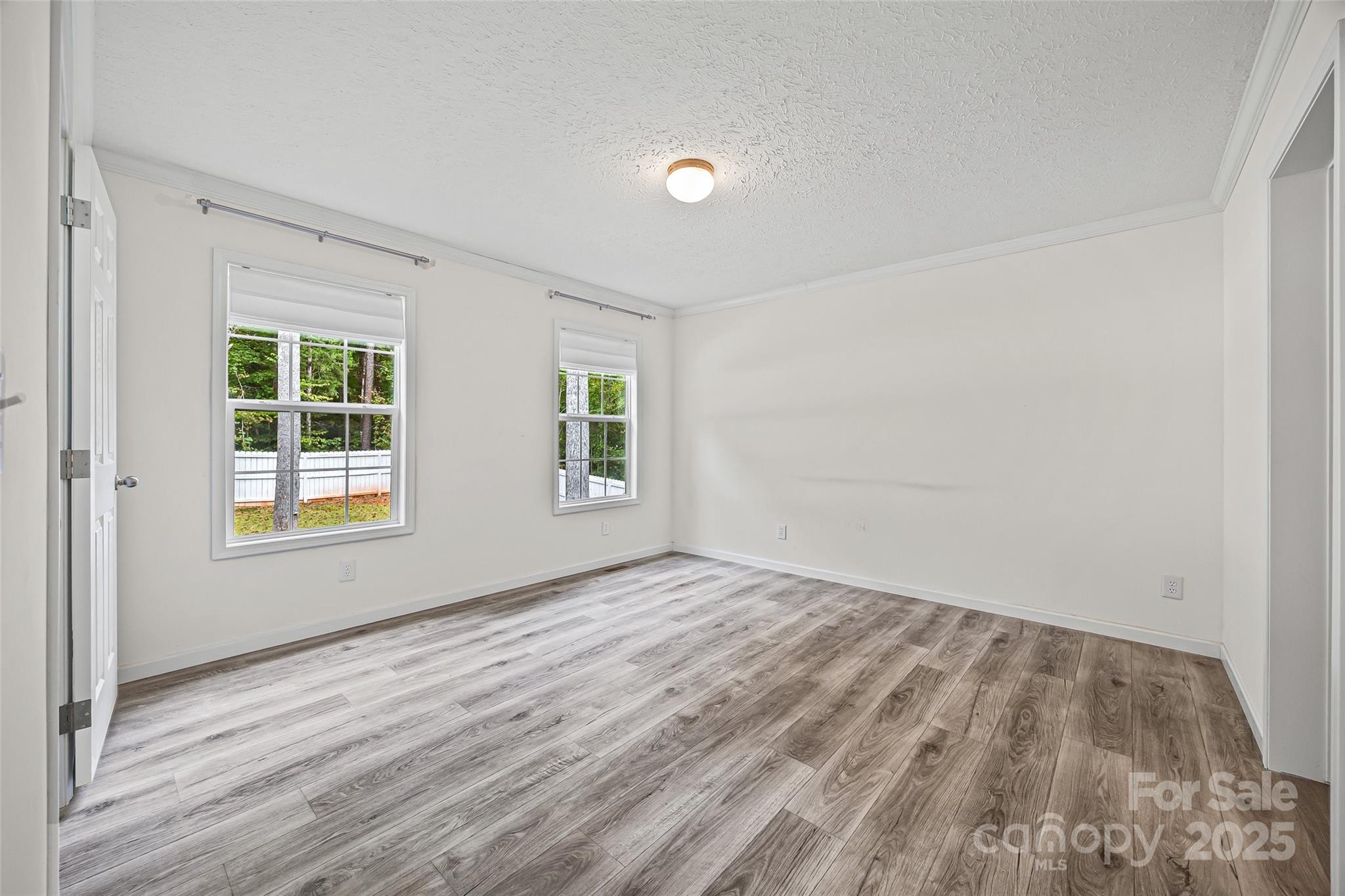 2025 Kisatchie Drive Hickory Grove, SC 29717 - Photo 14 of 33 a view of an empty room with wooden floor and a window