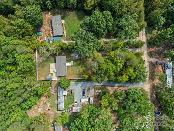 an aerial view of a house with a yard and garden