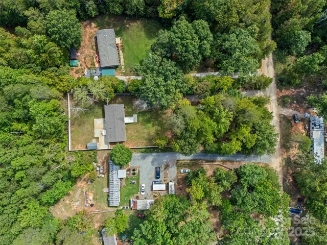 an aerial view of a house with a yard and garden