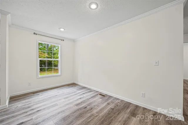 a view of room with window and hardwood floor