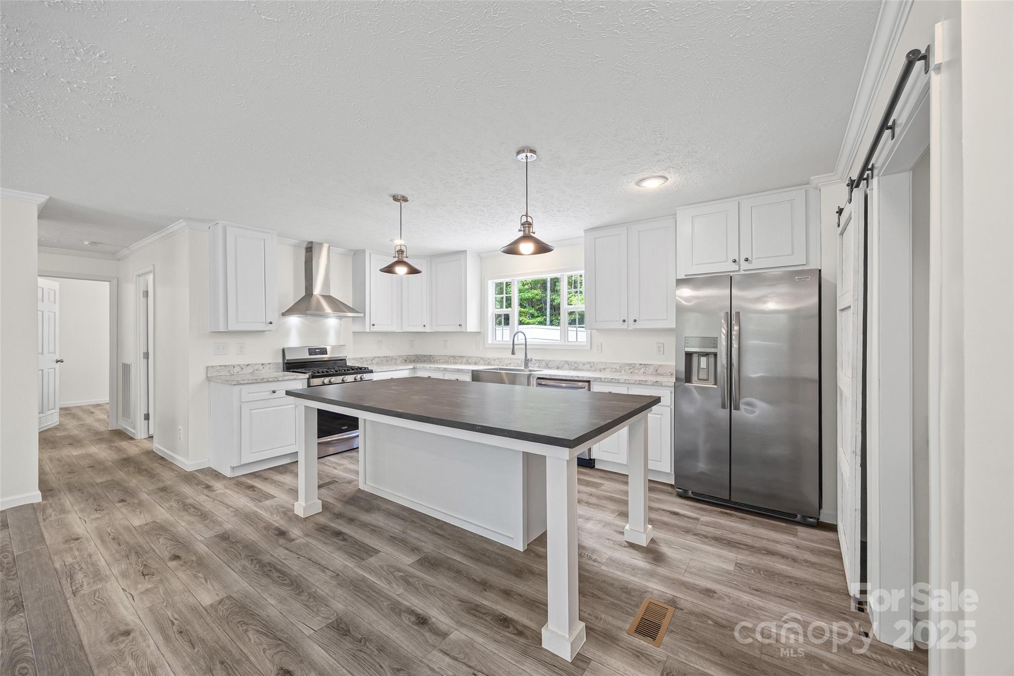 2025 Kisatchie Drive Hickory Grove, SC 29717 - Photo 9 of 33 a kitchen with kitchen island granite countertop a sink cabinets and stainless steel appliances