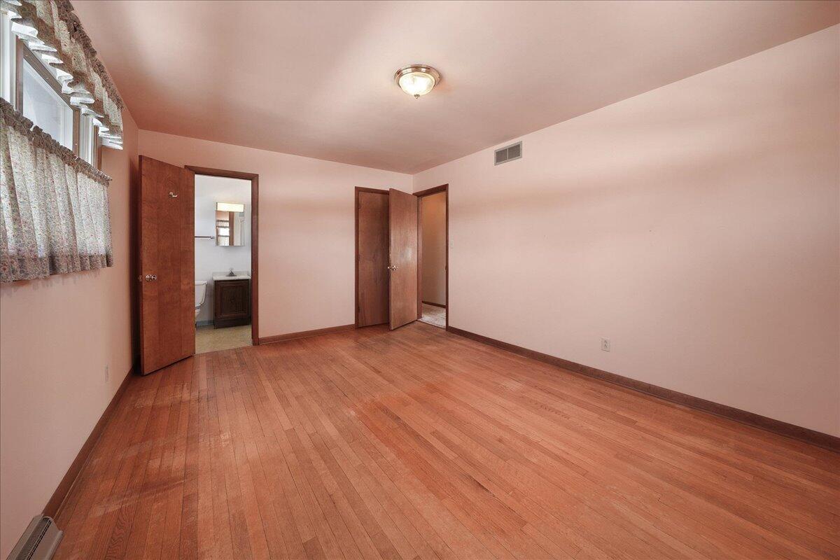 805 West Wilson Street Hebron, IN 46341 - Photo 12 of 27 a view of an empty room with wooden floor and a window