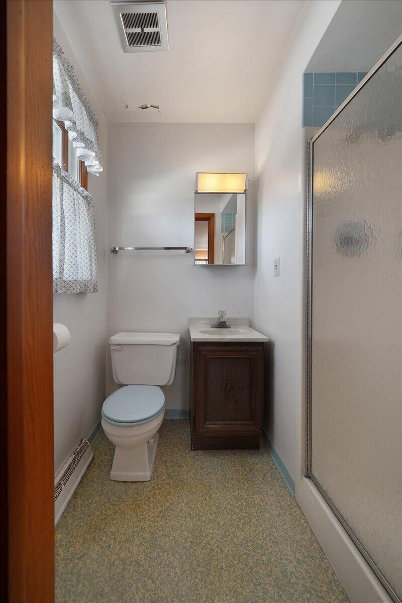 805 West Wilson Street Hebron, IN 46341 - Photo 13 of 27 a bathroom with a toilet sink and mirror