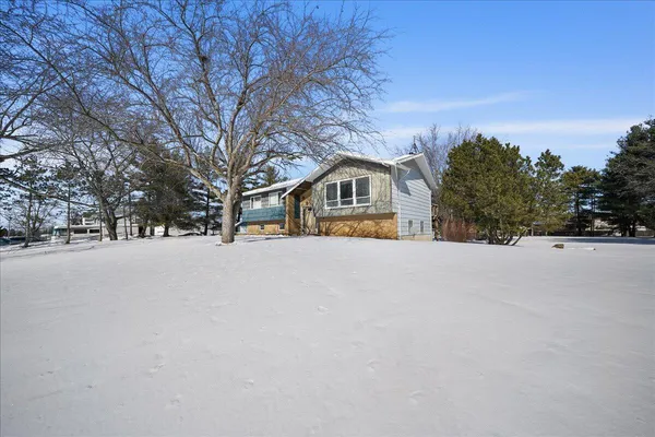 a view of house with snow on the road