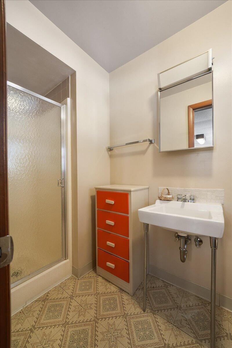 805 West Wilson Street Hebron, IN 46341 - Photo 22 of 27 a bathroom with a sink a light fixture and a mirror