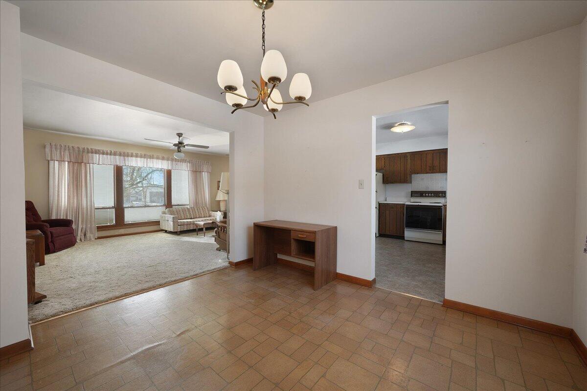 805 West Wilson Street Hebron, IN 46341 - Photo 8 of 27 a view of a livingroom with a fireplace a chandelier and windows
