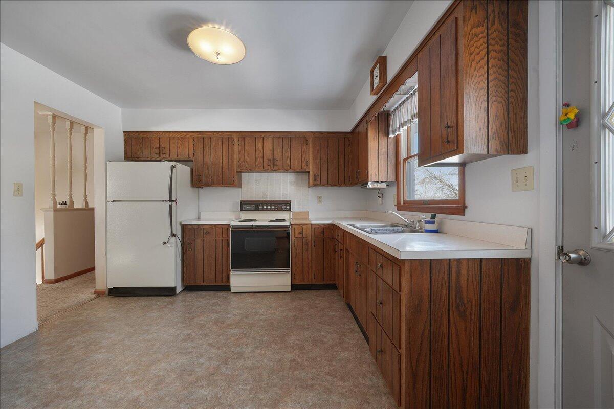 805 West Wilson Street Hebron, IN 46341 - Photo 10 of 27 a kitchen with a refrigerator sink and cabinets