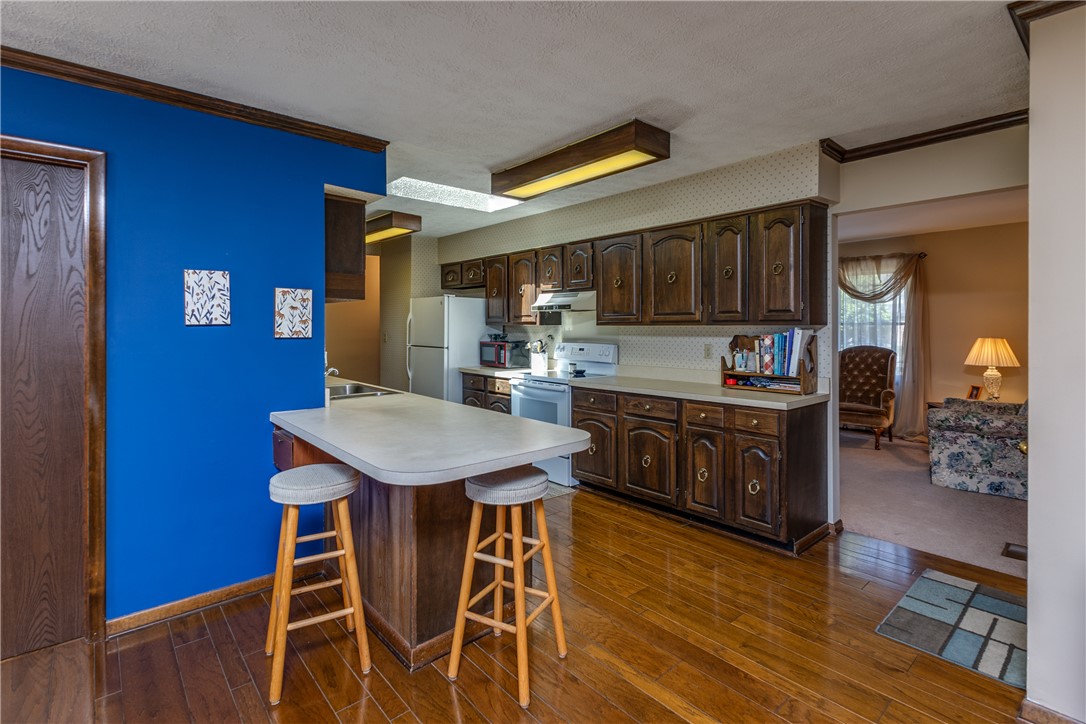4210 Pleasanton Road Englewood, OH 45322 - Photo 12 of 34 This spacious kitchen offers ample cabinetry and an inviting breakfast bar for casual dining.