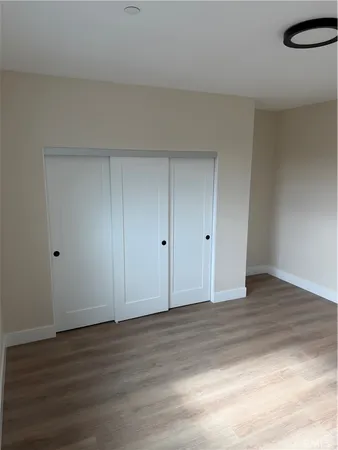 a view of an empty room and wooden floor