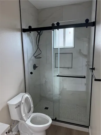 a bathroom with a toilet and a shower