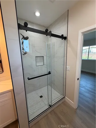 a bathroom with a shower and a mirror