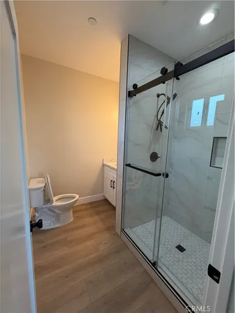 a bathroom with a glass shower door