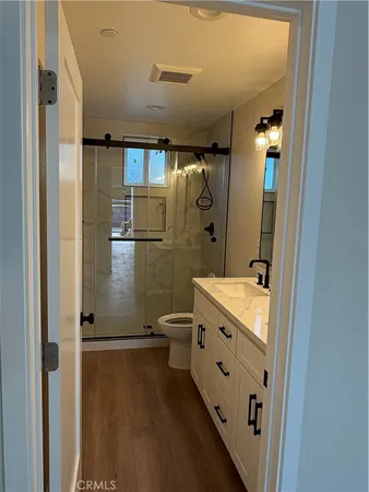 a bathroom with a double vanity sink toilet and shower