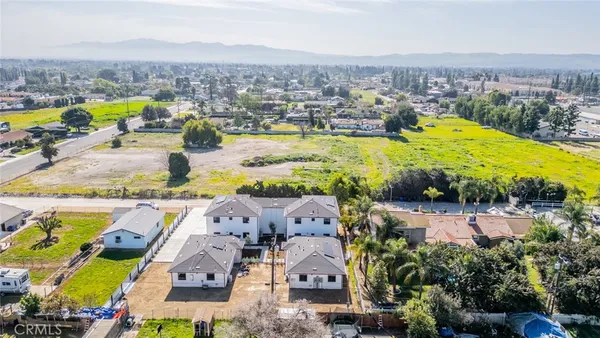 an aerial view of residential houses with outdoor space and swimming pool